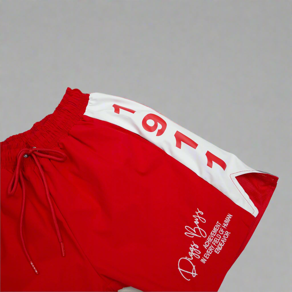 Red shorts with white accents and text on a light gray background.The Kappa Alpha Psi red Summer Short is a collectible item that represents the historical memorabilia of Kappa Alpha Psi Fraternity Inc . It is a symbol of pride and heritage for members of the Kappa Alpha Psi Fraternity, showcasing their commitment to their values and traditions from 1911. This short is a tangible piece of history that serves as a reminder of the legacy and contributions of the organization.
