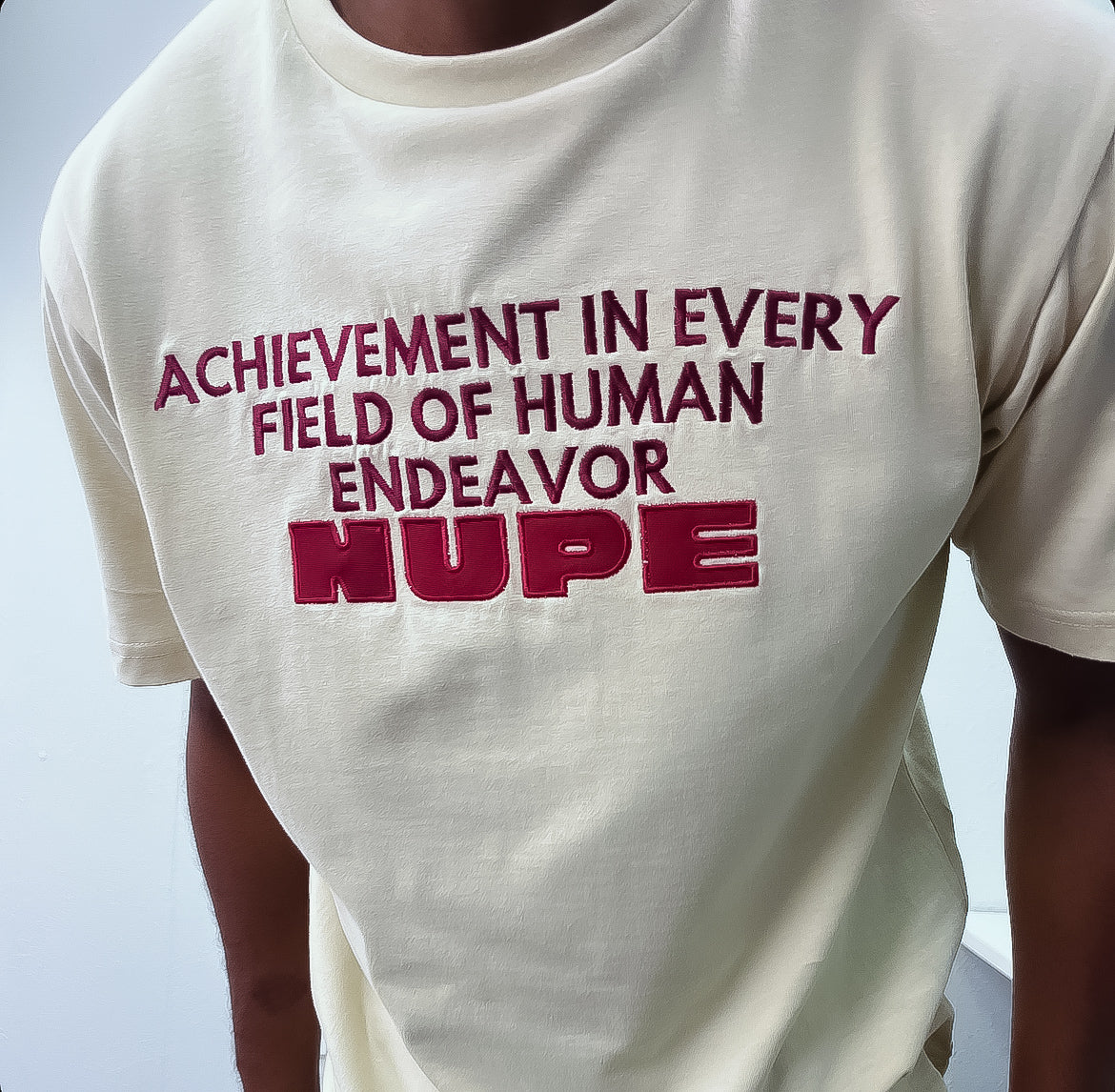 Show your Kappa Alpha Psi pride with this stylish "Nupe" T-shirt in a cream color. Perfect for fraternal events, this shirt features the iconic Greek letters and is made for members of the Fraternity & organization. Wear it to show your dedication to the Kappa Alpha Psi brotherhood and join the legacy of this historical fraternal organization.