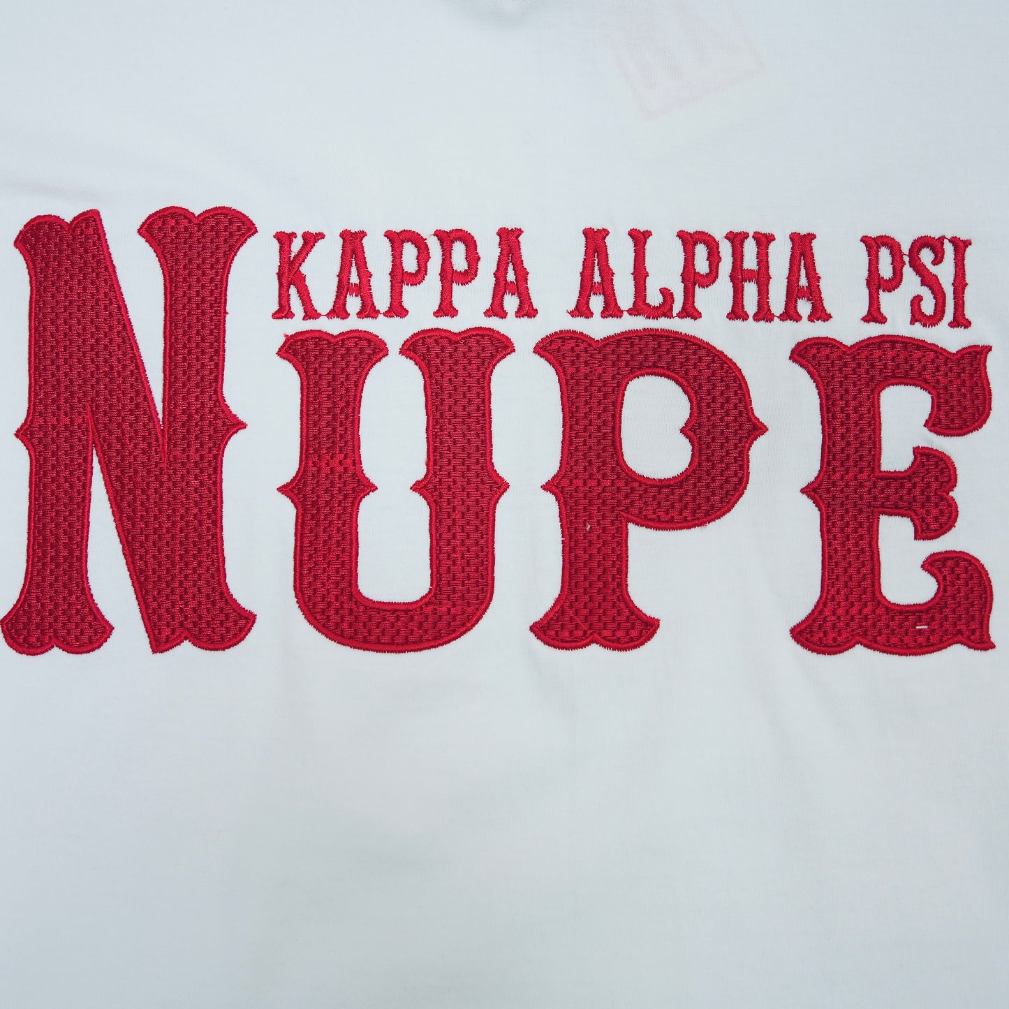 Red 'Kappa Alpha Psi NUPE' text on a white background.The Kappa Alpha Psi "Nupe" T-shirt is a collectible item that represents the historical significance and traditions of the fraternity . It serves as a symbol of pride and belonging for members and supporters of Kappa Alpha Psi. This t-shirt is a unique piece of memorabilia that showcases the unique cultural heritage and shared values of those involved in the organization.