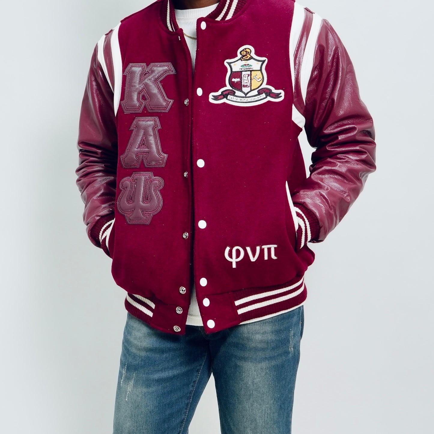 Maroon varsity jacket with Greek letters and emblem on a white background.The Kappa Alpha Psi Letterman Varsity Jacket is a collectible item that showcases the history and symbolism of the fraternity organization. Made with durable materials, this jacket is designed to last and serve as a tangible reminder of the values and traditions upheld by members of Kappa Alpha Psi. Perfect for Nupe looking to show their pride and affiliation with the organization.
