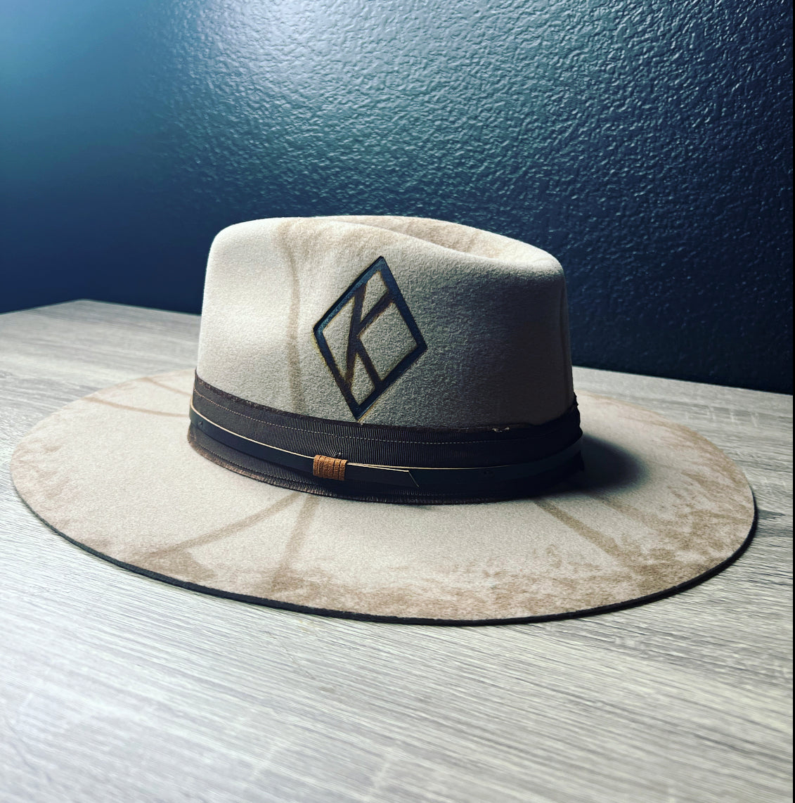 Elevate your style with this premium Kappa Alpha Psi fedora. Crafted from high-quality wool, this hat exudes sophistication and class. Perfect for the modern man who wants to make a fashion statement, this fedora features the iconic Kappa branding, showcasing your love for the fraternity. Designed for men who appreciate quality and elegance, this fedora is perfect for any occasion.
