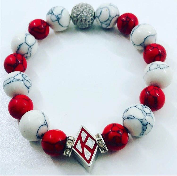Kappa Alpha Psi fraternity exclusive Glass Beaded Bracelet on elastic stretch rope; simple and elegant. Easy bracelet to slide on and off wrist. The color of amber beads may vary from bracelet to bracelet due to each bracelet being hand made from natural materials with a personal touch.