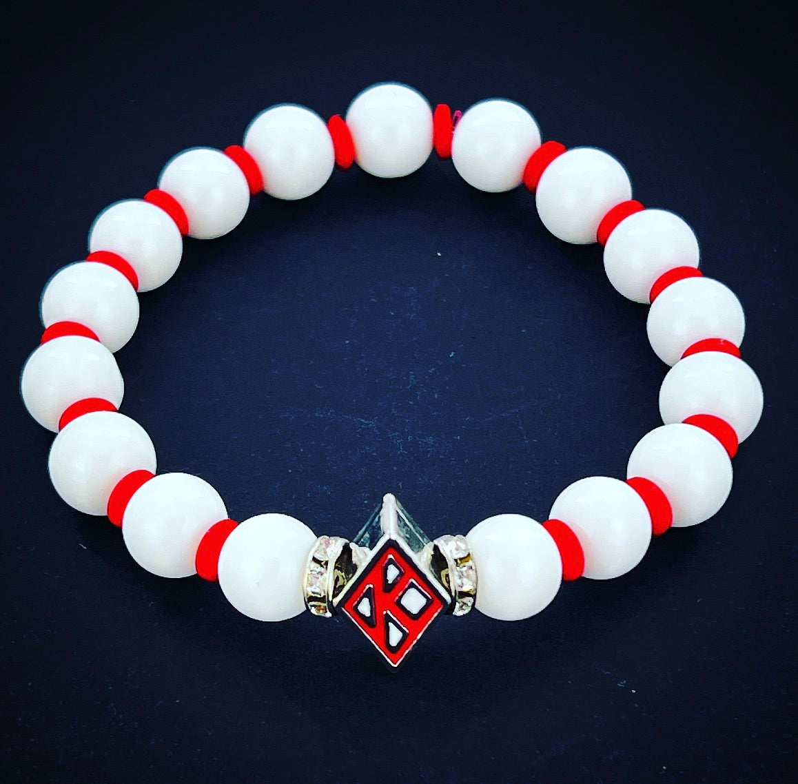 Kappa Alpha Psi fraternity exclusive Glass Beaded Bracelet on elastic stretch rope; simple and elegant. Easy bracelet to slide on and off wrist. The color of amber beads may vary from bracelet to bracelet due to each bracelet being hand made from natural materials with a personal touch.