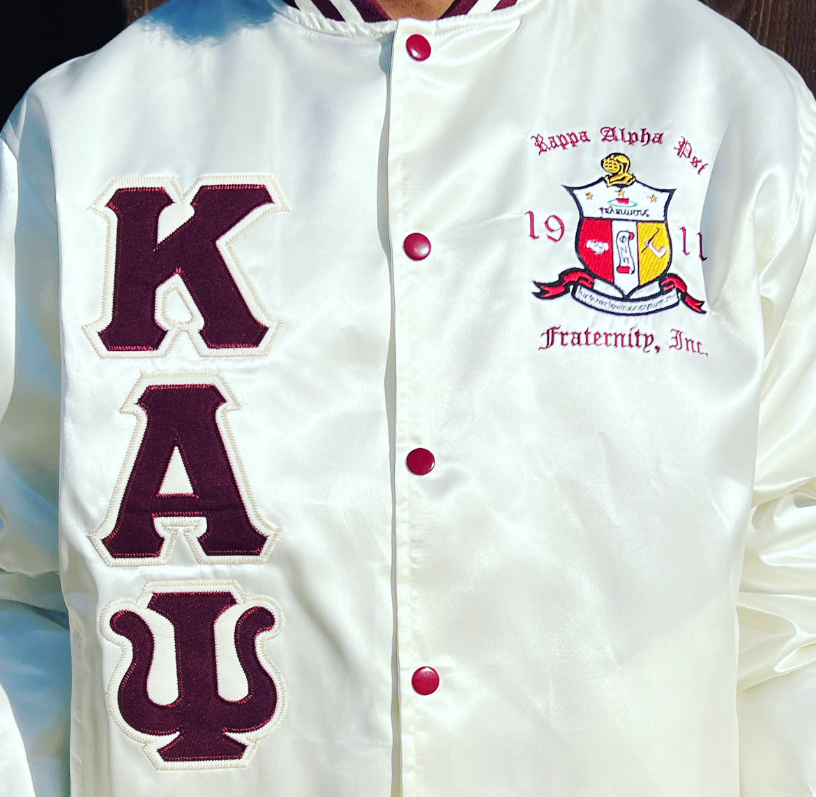 Check out our Kappa Alpha Psi satin jacket selection for the very best in unique design. This Kappa Alpha Psi Baseball Satin Jacket shows the fraternity Shield embroidered on left chest and Greek letters on right to create style and unique comfort in wear. Quality beyond imagination.
