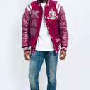 Red varsity jacket with white lettering and blue jeans on a white background.The Kappa Alpha Psi Letterman Varsity Jacket is a collectible item that showcases the history and symbolism of the fraternity organization. Made with durable materials, this jacket is designed to last and serve as a tangible reminder of the values and traditions upheld by members of Kappa Alpha Psi. Perfect for Nupe looking to show their pride and affiliation with the organization.