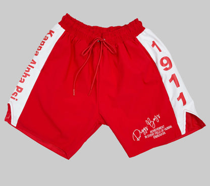 Red shorts with white accents and text on a light gray background.The Kappa Alpha Psi red Summer Short is a collectible item that represents the historical memorabilia of Kappa Alpha Psi Fraternity Inc . It is a symbol of pride and heritage for members of the Kappa Alpha Psi Fraternity, showcasing their commitment to their values and traditions from 1911. This short is a tangible piece of history that serves as a reminder of the legacy and contributions of the organization.