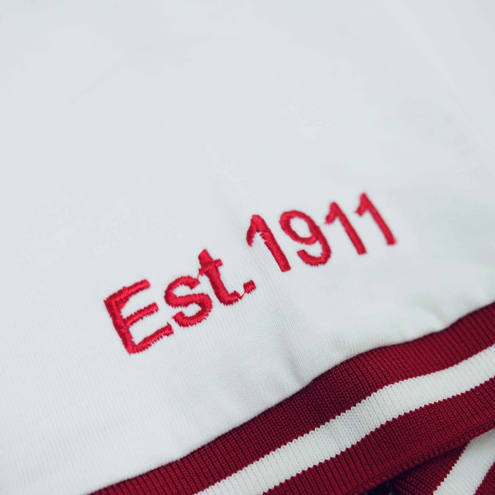 Embroidered 'Est. 1911' on a white background with red and white stripes.The Kappa Alpha Psi "Nupe" T-shirt is a collectible item that represents the historical significance and traditions of the fraternity . It serves as a symbol of pride and belonging for members and supporters of Kappa Alpha Psi. This t-shirt is a unique piece of memorabilia that showcases the unique cultural heritage and shared values of those involved in the organization.
