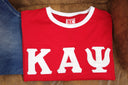 The shirt is perfect for those who appreciate quality and style. It is a great addition to any collection and is sure to turn heads. Whether you're dressing up or down, this Kappa Alpha Psi Shoulder Stripe T-Shirt is a versatile piece that can be worn for any occasion.