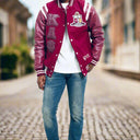 Person wearing a maroon varsity jacket with lettering and a white shirt underneath on a light gray background.The Kappa Alpha Psi Letterman Varsity Jacket is a collectible item that showcases the history and symbolism of the fraternity organization. Made with durable materials, this jacket is designed to last and serve as a tangible reminder of the values and traditions upheld by members of Kappa Alpha Psi. Perfect for Nupe looking to show their pride and affiliation with the organization, this jacket is a 