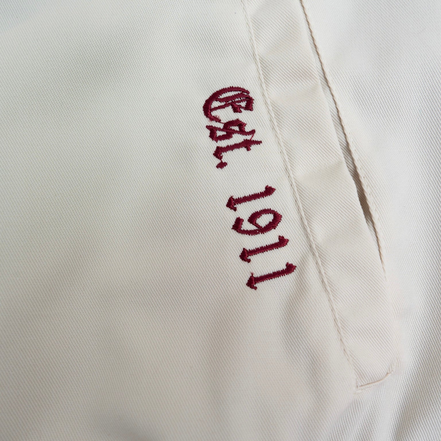 Embroidered text 'Est. 1911' on a white background.The Kappa Alpha Psi Cream Twill Jacket is a stylish and classic outerwear option for men. Made with durable twill material, this jacket features the signature ivory/ cream color of the Nupe Kave brand. It is designed with regular sizing in mind, making it a versatile option for a variety of men's sizes. Perfect for adding a touch of sophistication to any outfit, this jacket is a must-have for any man looking to showcase their Kappa Alpha Psi pride in style.