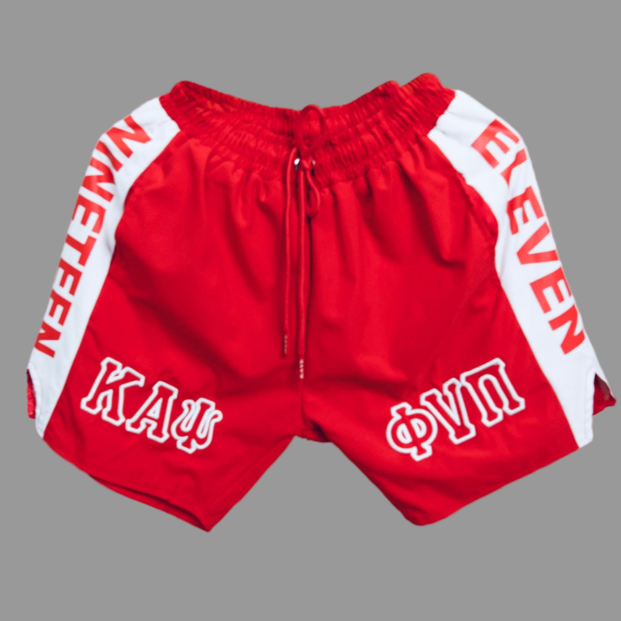 The Kappa Alpha Psi “Phi Nu Pi” Red And White Shorts are a collectible item that represents the historical significance of Kappa Alpha Psi Fraternity Inc. These shorts are a symbol of pride and unity among members in Phi Nu Pi, showcasing their commitment to the principles of the Kappa Alpha Psi Fraternity. Made in red and white, these shorts are a unique piece of memorabilia that serves as a reminder of the bond shared among brothers and members. Red shorts with white text on a gray background