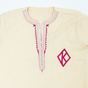 CREAM garment with embroidered design and logo on a white background.The product is Kappa Alpha Psi African Wear, specifically designed for members of the prestigious African American fraternity. This apparel is a symbol of pride and unity among the members of the organization, showcasing their heritage and cultural background. With the iconic symbols and colors of Kappa Alpha Psi, this African wear is a must-have for any member looking to represent their fraternity in a stylish and meaningful way.