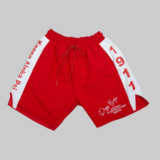 Red shorts with white accents and branding on a light gray background.The Kappa Alpha Psi red Summer Short is a collectible item that represents the historical memorabilia of Kappa Alpha Psi Fraternity Inc . It is a symbol of pride and heritage for members of the Kappa Alpha Psi Fraternity, showcasing their commitment to their values and traditions from 1911. This short is a tangible piece of history that serves as a reminder of the legacy and contributions of the organization.