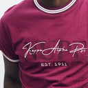 This Kappa Alpha Psi Premium NUPE Crimson T-Shirt is a must-have for any member of the organization. Made of high-quality cotton material, this regular-fit T-shirt features a crew neck and short sleeves, making it perfect for everyday wear. The shirt comes in a cream color with a solid pattern, and the Kappa Alpha Psi brand is prominently displayed on the front.