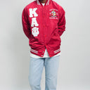 Red varsity jacket with white lettering and design on a gray background.Check out our Kappa Alpha Psi satin jacket selection for the very best in unique design. This Kappa Alpha Psi Baseball Nylon Jacket shows the fraternity Shield embroidered on left chest and Greek letters on right to create style and unique comfort in wear. Quality beyond imagination.
