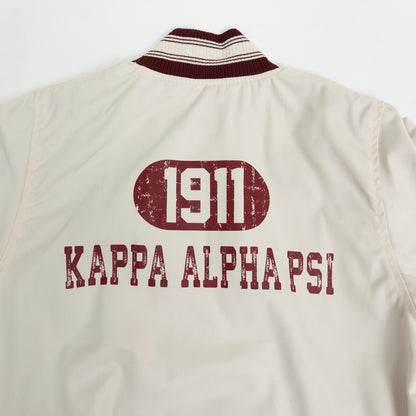 Beige jacket with '1911 Kappa Alpha Psi' text on a white background