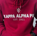 Show off your fraternity pride with this stylish dark red and cream hoodie featuring the Kappa Alpha Psi organization. Perfect for any casual occasion, this hoodie is a must-have for any fraternity member. The bold colors and recognizable logo make a statement while providing comfortable warmth. Represent your organization with pride and stay cozy in this must-have hoodie.
