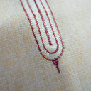 Close-up of intricate embroidery on fabric with red thread.The product is Kappa Alpha Psi African Wear, specifically designed for members of the prestigious African American fraternity. This apparel is a symbol of pride and unity among the members of the organization, showcasing their heritage and cultural background. With the iconic symbols and colors of Kappa Alpha Psi, this African wear is a must-have for any member looking to represent their fraternity in a stylish and meaningful way.