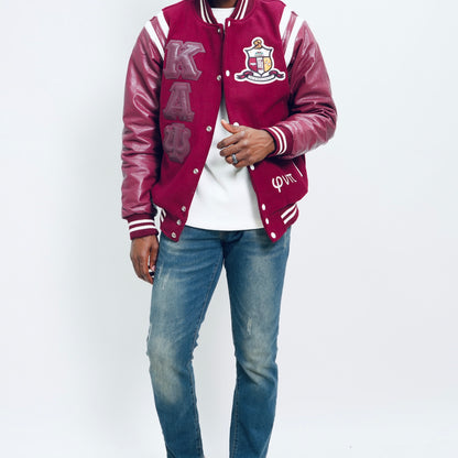 Person wearing a maroon varsity jacket with white lettering on a white background.The Kappa Alpha Psi Letterman Varsity Jacket is a collectible item that showcases the history and symbolism of the fraternity organization. Made with durable materials, this jacket is designed to last and serve as a tangible reminder of the values and traditions upheld by members of Kappa Alpha Psi. Perfect for Nupe looking to show their pride and affiliation with the organization, this jacket is a piece of fraternal.