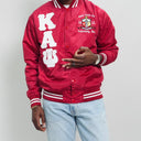 Red letterman jacket with white lettering and a logo, worn by a person against a plain background.Check out our Kappa Alpha Psi satin jacket selection for the very best in unique design. This Kappa Alpha Psi Baseball Nylon Jacket shows the fraternity Shield embroidered on left chest and Greek letters on right to create style and unique comfort in wear. Quality beyond imagination.
