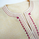 Close-up of a garment with intricate embroidery on a beige background.The product is Kappa Alpha Psi African Wear, specifically designed for members of the prestigious African American fraternity. This apparel is a symbol of pride and unity among the members of the organization, showcasing their heritage and cultural background. With the iconic symbols and colors of Kappa Alpha Psi, this African wear is a must-have for any member looking to represent their fraternity in a stylish and meaningful way.
