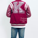 Maroon letterman jacket with a large 'K' on the back, worn by a person, on a white backgroundThe Kappa Alpha Psi Letterman Varsity Jacket is a collectible item that showcases the history and symbolism of the fraternity organization. Made with durable materials, this jacket is designed to last and serve as a tangible reminder of the values and traditions upheld by members of Kappa Alpha Psi. Perfect for Nupe looking to show their pride and affiliation with the organization.