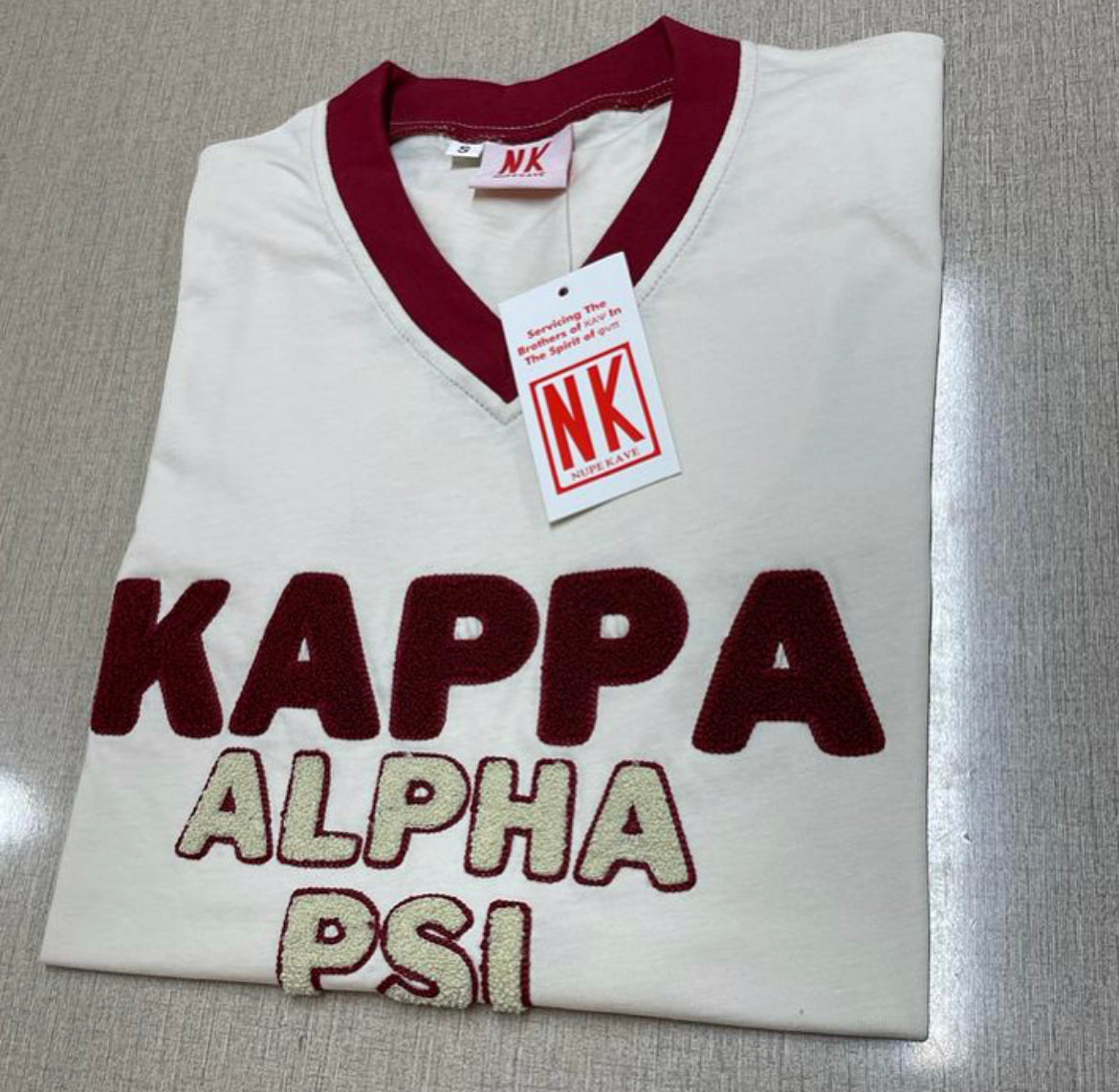 Exclusive Kappa Alpha Psi Double Chenille Lettered T-shirt . This is the perfect short-sleeved shirt to wear while showing off your Kappa Alpha Psi fraternity lettering. A comfortable 100% cotton tee with a twill Greek letters embroidery across the chest give you the perfect fit. This shirt is also a perfect gift for your favorite Kappa Man.