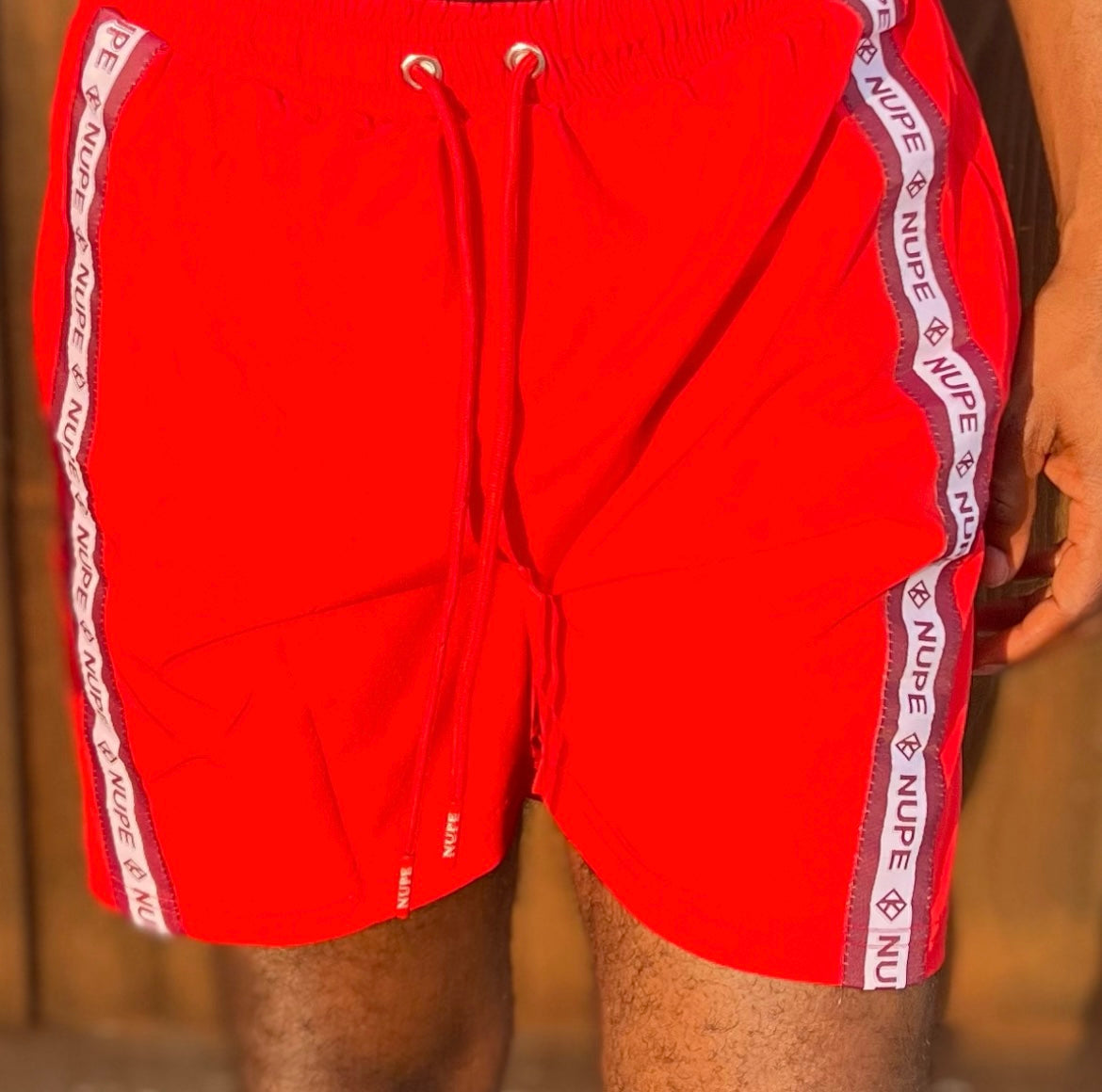 Enjoy your spring & summer with a Nupe Kave shorts constructed from a premium polyester blend that is ultra-soft and comfortable. This short is lightweight with moisture-wicking fabric is antimicrobial to keep you dry and feeling fresh. Perfect for an early morning workout or dip in the ocean while on vacation. Finished with pockets and an elasticated waist band with drawstrings for the phones and extra items.