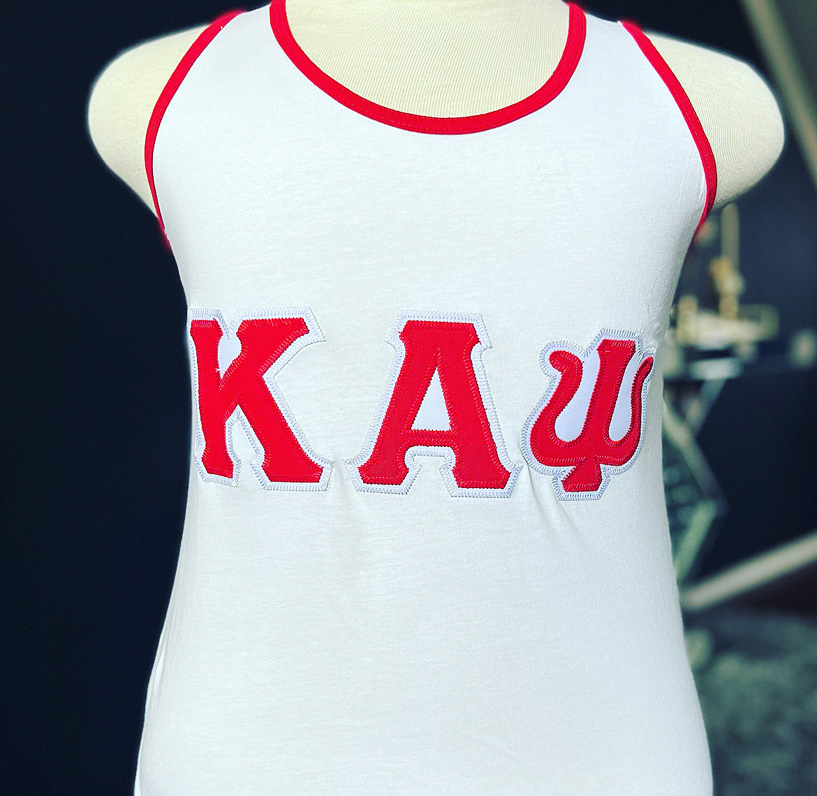 Exclusive Kappa Alpha Psi Tank Top . This is the perfect short-sleeved shirt to wear while showing off your Kappa Alpha Psi fraternity lettering. A comfortable 100% cotton tee with a twill Greek letters embroidery across the chest give you the perfect fit. This shirt is also a perfect gift for your favorite Kappa Man.