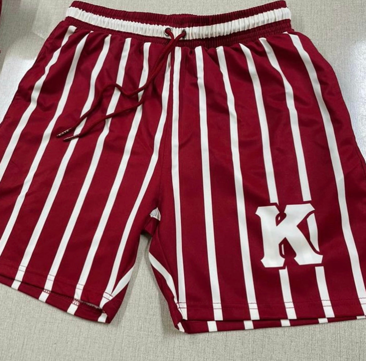 Elevate your summer style with these Kappa Alpha Psi men's swim shorts. Featuring a classic striped pattern and convenient drawstring waist, these swim shorts are the perfect addition to your swimwear collection. Made for men, these swim shorts offer a comfortable fit and are suitable for any beach or poolside adventure.