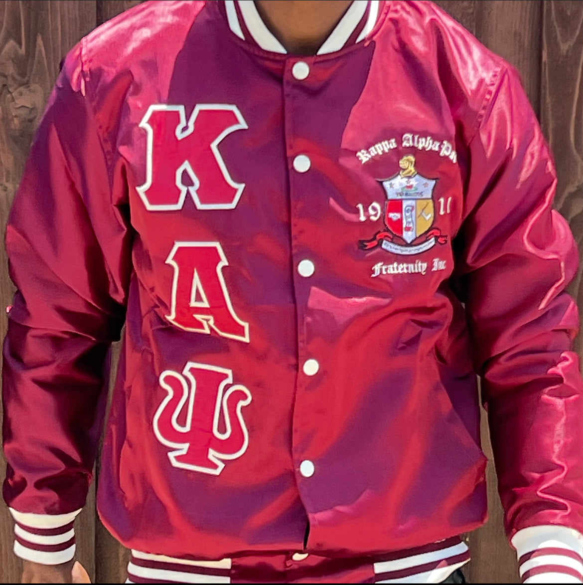 Check out our Kappa Alpha Psi satin jacket selection for the very best in unique design. This Kappa Alpha Psi Baseball Satin Jacket shows the fraternity Shield embroidered on left chest and Greek letters on right to create style and unique comfort in wear. Quality beyond imagination.