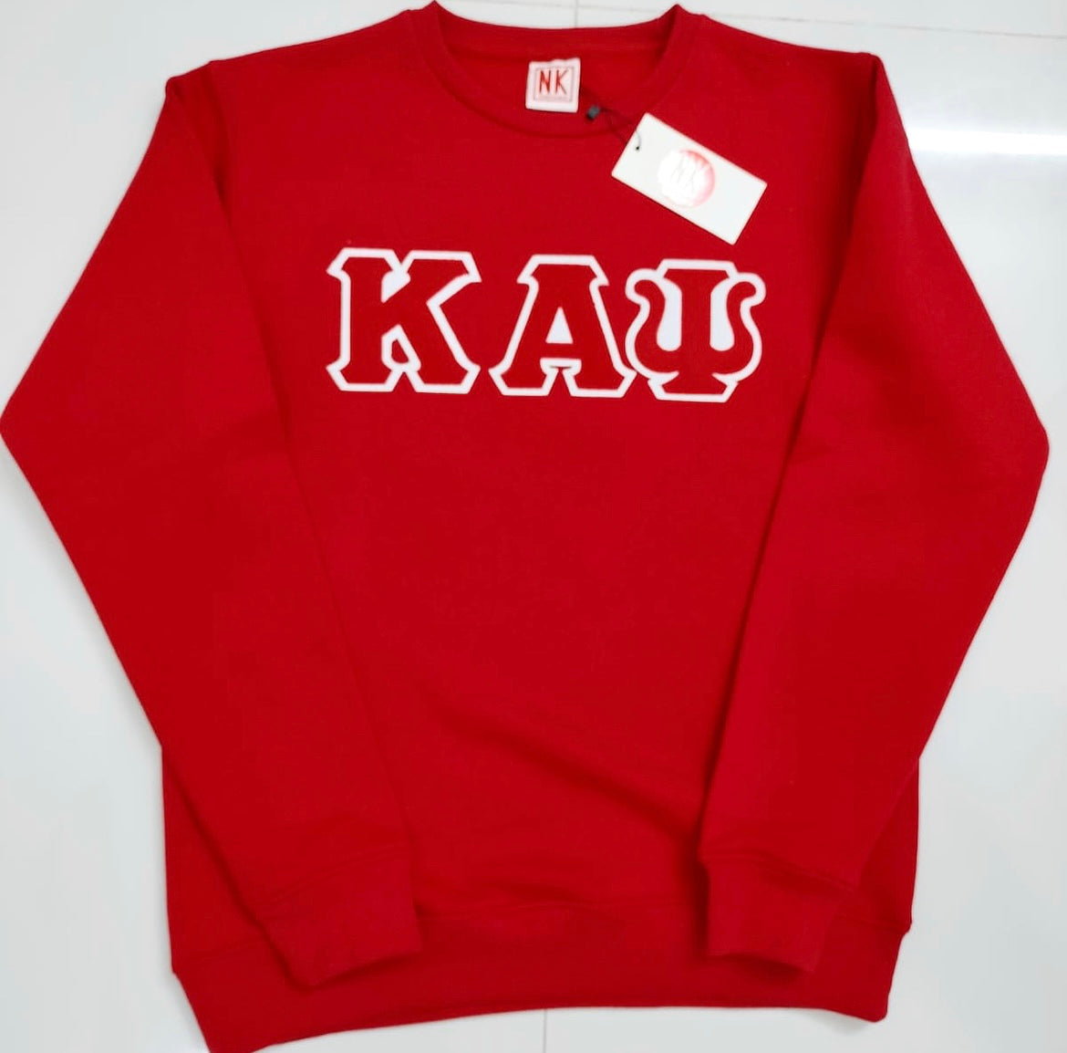 Exclusive Kappa Alpha Psi Double Stitched Appliqué Embroidery Lettered Red Sweater. This is the perfect long-sleeved Sweater to wear while showing off your Kappa Alpha Psi fraternity lettering. A comfortable 100% cotton tee with a twill Greek letters embroidery across the chest give you the perfect fit. This sweater is also a perfect gift for your favorite Kappa Man.