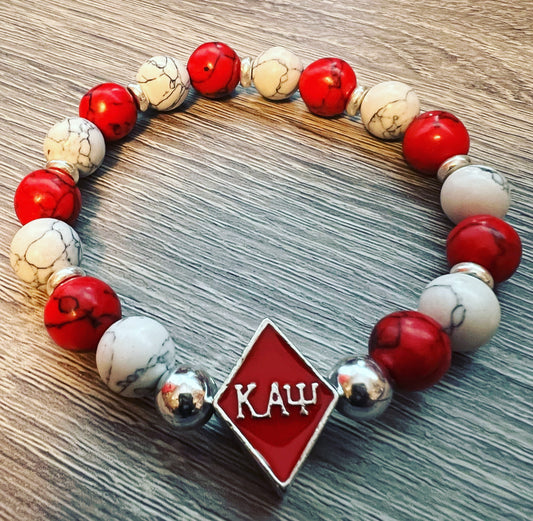 Kappa Alpha Psi fraternity exclusive Glass Beaded Bracelet on elastic stretch rope; simple and elegant. Easy bracelet to slide on and off wrist. The color of amber beads may vary from bracelet to bracelet due to each bracelet being hand made from natural materials with a personal touch.