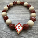 Kappa Alpha Psi fraternity exclusive Glass Beaded Bracelet on elastic stretch rope; simple and elegant. Easy bracelet to slide on and off wrist. The color of amber beads may vary from bracelet to bracelet due to each bracelet being hand made from natural materials with a personal touch.