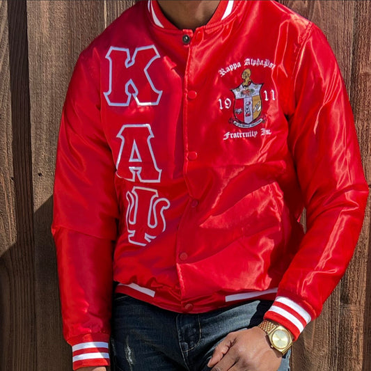 Check out our Kappa Alpha Psi satin jacket selection for the very best in unique design. This Kappa Alpha Psi Baseball Satin Jacket shows the fraternity Shield embroidered on left chest and Greek letters on right to create style and unique comfort in wear. Quality beyond imagination.