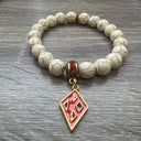 Kappa Alpha Psi fraternity exclusive Glass Beaded Bracelet on elastic stretch rope; simple and elegant. Easy bracelet to slide on and off wrist. The color of amber beads may vary from bracelet to bracelet due to each bracelet being hand made from natural materials with a personal touch.
