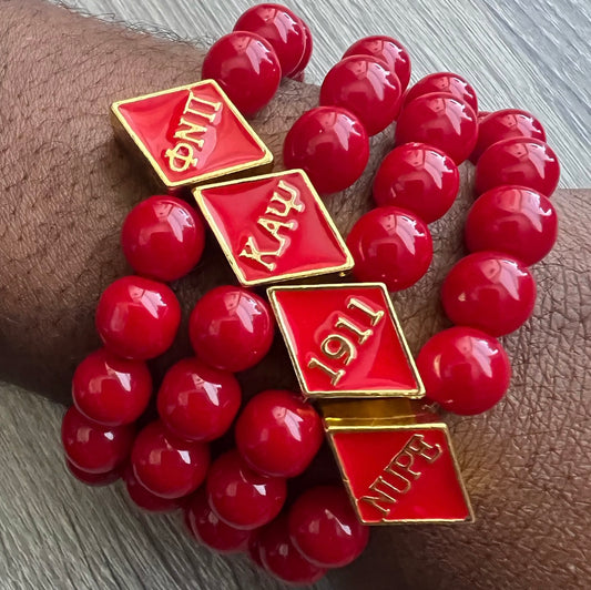 Kappa Alpha Psi fraternity exclusive Glass Beaded Bracelet on elastic stretch rope; simple and elegant. Easy bracelet to slide on and off wrist. The color of amber beads may vary from bracelet to bracelet due to each bracelet being hand made from natural materials with a personal touch.