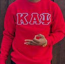 Exclusive Kappa Alpha Psi Double Stitched Appliqué Embroidery Lettered Red Sweater. This is the perfect long-sleeved Sweater to wear while showing off your Kappa Alpha Psi fraternity lettering. A comfortable 100% cotton tee with a twill Greek letters embroidery across the chest give you the perfect fit. This sweater is also a perfect gift for your favorite Kappa Man.